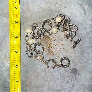 Silver and pearl three-stand connected toggle bracelet.